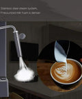 Close-up of stainless steel steam system on semi automatic espresso machine, creating dense milk foam for lattes.