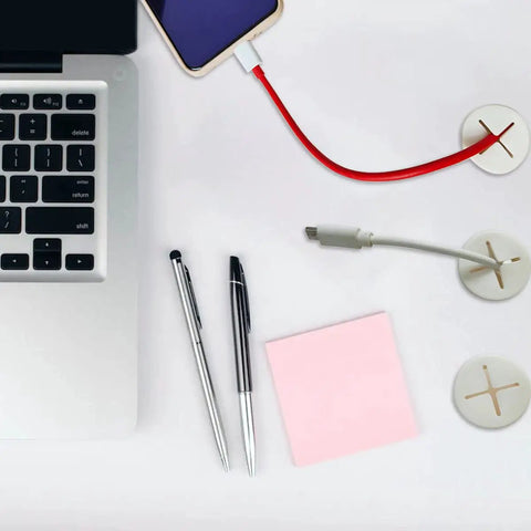6 Pack Pure White Silicone Desk Cord Grommet, 1 Inch Flexible Wire Protector And Slick Cable Patch For Tables in use with cables.