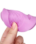 Close-up of a pink silicone mold for hot air balloon chocolate and fondant decorating, detailed texture visible in hand.