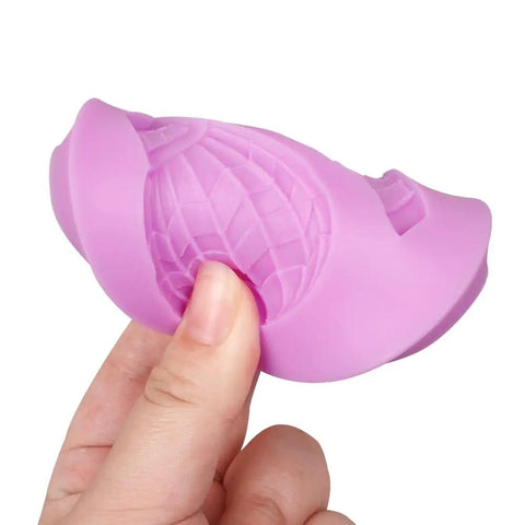 Close-up of a pink silicone mold for hot air balloon chocolate and fondant decorating, detailed texture visible in hand.