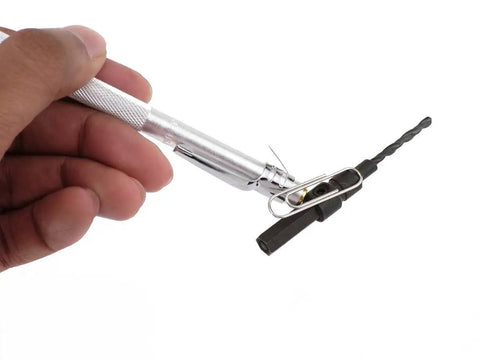 Heavy Duty Tungsten Carbide Scriber Engraving Pen For Marking Steel Metal Wood With Reversible Index Chuck Knockout Shop Tool Hella Tough For Mechanics And DIY Crafters Projects Silver Medium Gauge held in hand with reversible chuck.