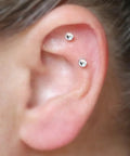 Close-up of ear with two cartilage piercings using threadless stud jewelry from Threadless Piercing Tapers Set Go To For Changing And Insertion Tools 16G 18G 20G Titanium Threadless Insertion Pins Includes 3 Pcs Piercing Tapers And Change Tool Flat Back Earring Applicator For Most Threadless Stud Jewelry.