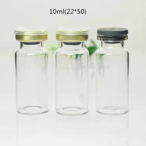 Front view: three 10ml clear glass vials with aluminum flip-off caps (gold and gray), empty lab sample bottles.