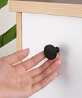 Top Shelf 4 Pack Matte Black Cabinet Knobs, Round Drawer Pulls And Modern Dresser Handles, close-up view with a hand gripping the knob.