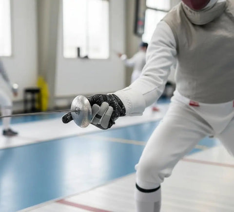 Fencer wearing Dope Style Fencing Glove With Padded Amara Leather And Real Leather For Foil Epee And Saber Silicoated Palm Neoprene Back 350N Cuff.