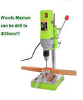 Beefy 710W Mini Drill Press With Cast Iron Base shown drilling wood, highlighting variable speed and 1-13mm chuck features.