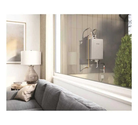 Mad Fast Instant Hot Water Flow Beige Natural Gas Tankless Water Heater mounted on the outside wall beside a cozy living room.