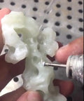 Craftsman using 30 Piece Ball Shape Diamond Burr Set for rotary tools, shaping a stone with precision and ease.
