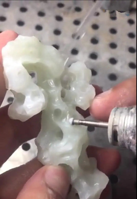 Craftsman using 30 Piece Ball Shape Diamond Burr Set for rotary tools, shaping a stone with precision and ease.