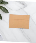60 Pack Self Adhesive Kraft Paper Envelopes 10.8 By 15.9 Cm Letter Size For Invitations And Cards Secure Seal displayed on table