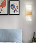 Modern Acrylic Led Wall Sconce With Up And Down Ambient Glow Includes A Smart Remote For Swift Dimming And Cool White Switches on bedroom wall.
