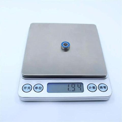 MR125RS 5x12x4 Mm ABEC-3 Blue Sealed 2RS Ball Bearing on digital scale showing weight