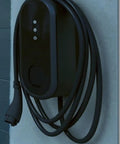 Level 2 EV Charger With 32 Amp 240 Volt Output For Rock Solid Home Or Garage Installations Featuring No Sweat Setup Heavy Duty Cord Fast Charging Station For Every Electric Ride mounted on a wall with a coiled cable.