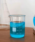 250ml glass beaker filled with blue liquid, part of 3 Piece Glass Beaker Set Lab Gear With 50ml 100ml 250ml Low Form Borosilicate 3.3 Lab Grade Beakers Featuring Double Scale For Pro Level Chemistry Experiments And Easy Measurement