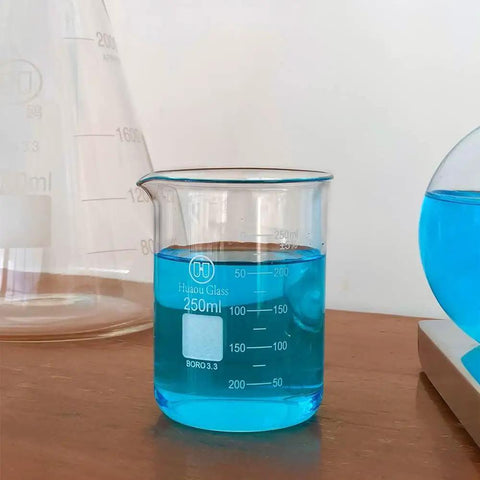 250ml glass beaker filled with blue liquid, part of 3 Piece Glass Beaker Set Lab Gear With 50ml 100ml 250ml Low Form Borosilicate 3.3 Lab Grade Beakers Featuring Double Scale For Pro Level Chemistry Experiments And Easy Measurement