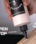 Heavy Duty Brown Wood Glue For Carpentry And Furniture Repair being applied from a bottle with an easy-open twist top.
