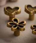 Bougie Antique Brass Flower Cabinet Knobs Vintage Aesthetic Boho Decor Hardware Set of 4 with heart and flower designs.