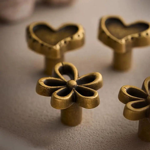 Bougie Antique Brass Flower Cabinet Knobs Vintage Aesthetic Boho Decor Hardware Set of 4 with heart and flower designs.
