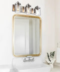 3 Light Vanity Bar Over Mirror With Brushed Nickel Finish And Clear Glass Shades in Bathroom
