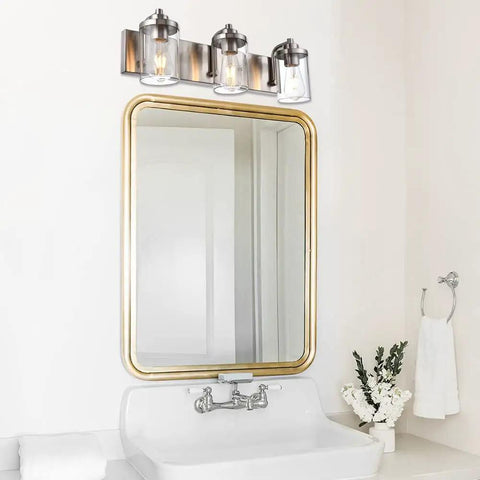 3 Light Vanity Bar Over Mirror With Brushed Nickel Finish And Clear Glass Shades in Bathroom
