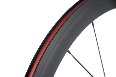 Close-up of 50mm carbon fiber track wheel set matte finish 3K fixed gear wheelset with cog built for speed junkies and long rides.