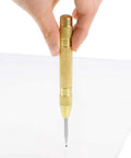 No Sweat Automatic Center Punch Four Piece Kit With Adjustable Spring Impact, solid brass body marking pilot holes on glass.