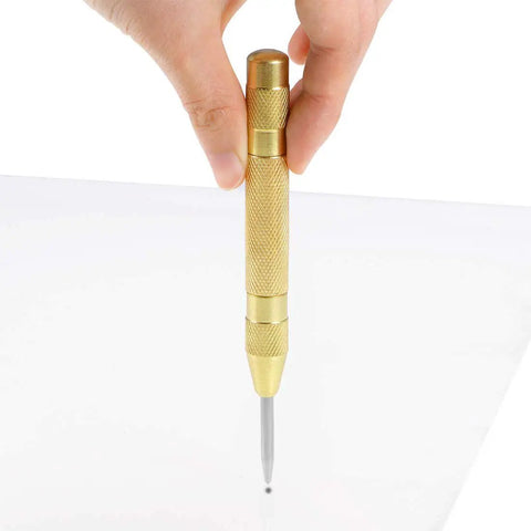 No Sweat Automatic Center Punch Four Piece Kit With Adjustable Spring Impact, solid brass body marking pilot holes on glass.