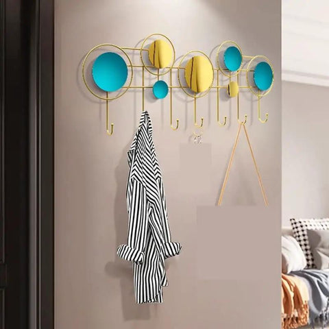 Built Different Wall Mounted Coat Hooks For Entryway with yellow and blue circles, gold hooks, holding a striped coat.