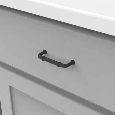 Matte black cabinet pull installed on gray drawer, part of 10 Pack Solid Core Cabinet Pulls Matte Black Cottage Collection 3 Inch Center To Center Hardware.