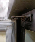 Close-up of a refrigerator hinge in need of repair, highlighting the wear on a door using 4 Piece Refrigerator Hinge Set with 35mm wheelbase.