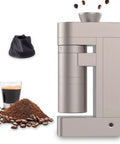 Heavy Duty Premium Electric Burr Coffee Grinder With Rock Solid 48mm Calibration For Epic Espresso Pulls And Fresh Morning Brews In Classic Champagne Gold Finish, showcasing ground coffee and espresso.
