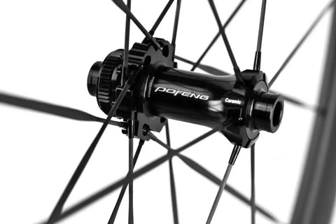 Carbon Disc Wheelset 50C Tubeless With Carbon Spokes Thru Axle Center Lock hub close-up; 12x100 front assembly detail.