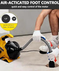 Heavy Duty Electric Drain Cleaner 30Ft Auto Feed Auger With Foot Switch, user operating the foot control for easy motor operation.