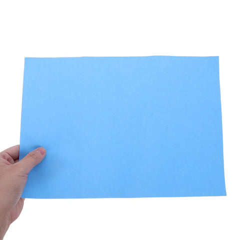 Colorful Carbon Tracing Paper Pack for Erasable Transfers on A4 Sheets, Perfect for Wood, Canvas, Embroidery and Crafts, Mess Free, Quick Copy, Ideal for Artists, Designers, and DIY Projects blue A4 sheet held by hand