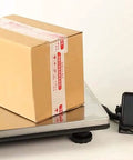 Heavy Duty Digital Postal Scale With Adjustable Viewing Head And Fold Away Handle Locks In Your Shipping Game Smooth Operator Parcel Workhorse Boasts Bright Lcd Screen For Fast Readings Up To 440 Pounds with a package on the platform.