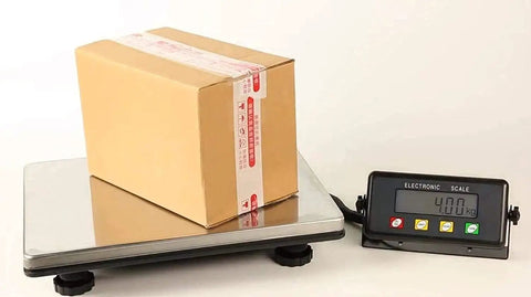 Heavy Duty Digital Postal Scale With Adjustable Viewing Head And Fold Away Handle Locks In Your Shipping Game Smooth Operator Parcel Workhorse Boasts Bright Lcd Screen For Fast Readings Up To 440 Pounds with a package on the platform.