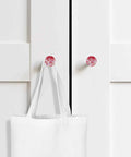Killer Red Abstract Painted Wooden Cabinet Knobs 2 Piece Set 1.4 Inch Round Drawer Pulls For Kitchen Cabinets on white cabinetry with tote bag.