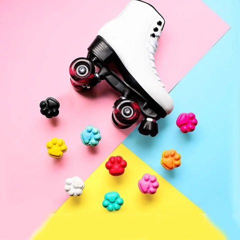 Two Pack Cat Paw Toe Stops For Quad Roller Skates 82A Rubber Brake Blocks with colorful paw shapes surrounding a white skate