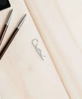 Stainless Steel R Shape Lock Pins For Industrial Hitch Assembly on wooden surface, showcasing heavy duty wavy design.