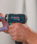 12 Volt Flexi Click Cordless Drill Driver With Magnetic Bit Holder Offset Angle Adapter Compact Bare Tool working on a wall socket.