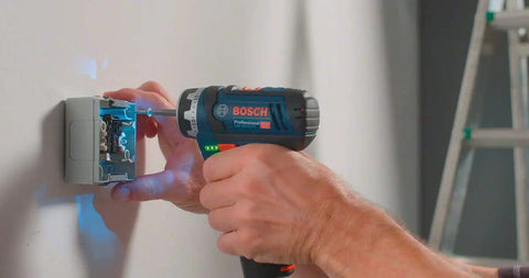 12 Volt Flexi Click Cordless Drill Driver With Magnetic Bit Holder Offset Angle Adapter Compact Bare Tool working on a wall socket.