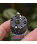 Close-up of electronic starter with planetary gearbox and full metal drive system D shaft compatible DC 12V 30 RPM for robotics
