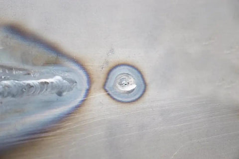 Close-up of a weld using AGK320 Hole Plug Magnet for Hands Free Welding With Pivoting Magnetic V Pad Base, showing precise hole weld.