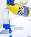 Pouring Badass Professional Floor Sealant With Tough Stain Guard for Vinyl VCT and Concrete from a one-gallon jug.