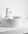 Straight Fire 15.7 Inch Diameter Round Ceramic Bathroom Vessel Sink With Integrated Faucet For Above Counter Installation And Quick Room Glow Up In Crisp White Finish on a countertop.