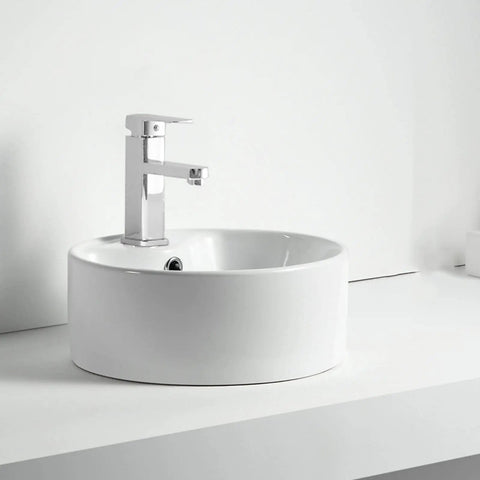 Straight Fire 15.7 Inch Diameter Round Ceramic Bathroom Vessel Sink With Integrated Faucet For Above Counter Installation And Quick Room Glow Up In Crisp White Finish on a countertop.