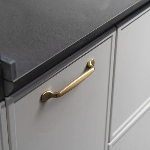 Six Pack 5 Inch Center To Center Arch Cabinet Pulls In Champagne Bronze Finish mounted on a kitchen drawer