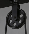 Close-up of the pulley mechanism on the Slick Industrial Vintage Pulley Led Chandelier With Refined Metal Frame.