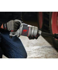 Pro Level One Inch Drive Air Impact Wrench Crafted For Boss Garage Tasks pumping out serious reverse torque, held by a mechanic.