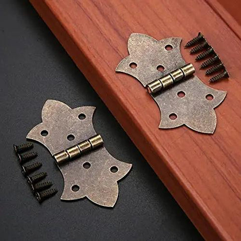 Antique Bronze Gold Flower Metal Butt Hinges For Cabinets And Jewelry Boxes 57 By 31mm with screws, displayed on a wooden surface.